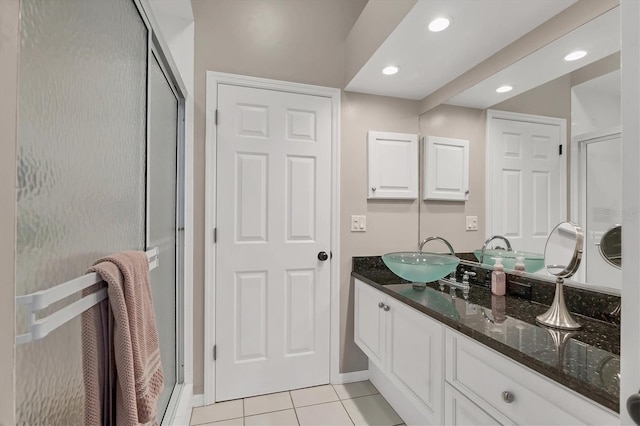 full bath featuring baseboards, tile patterned floors, vanity, a shower stall, and recessed lighting