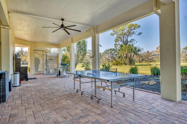 view of patio with outdoor dining space and a ceiling fan