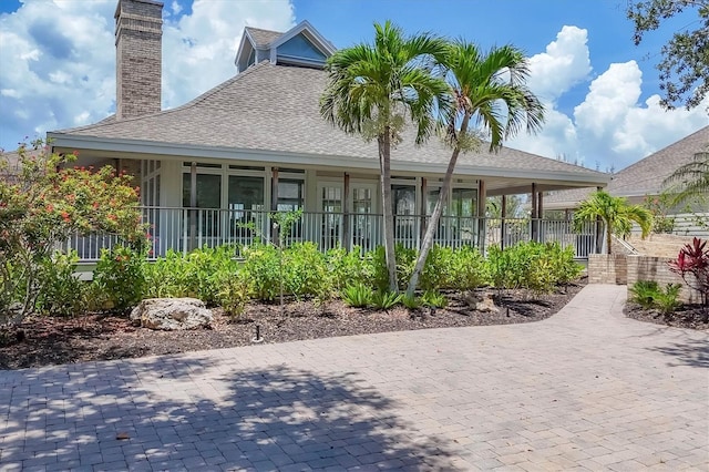 92 Tidy Island Blvd, Bradenton, FL 34210 - rear view of property featuring a chimney and a shingled roof