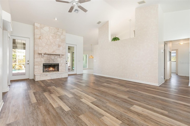 1730 Hudson St, Englewood, FL 34223 - unfurnished living room with high vaulted ceiling, a ceiling fan, a fireplace, wood finished floors, and baseboards