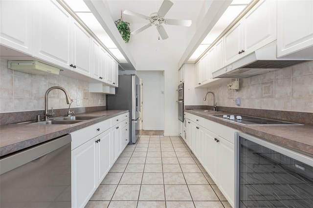 1730 Hudson St, Englewood, FL 34223 - kitchen featuring wine cooler, stainless steel appliances, a sink, and white cabinetry