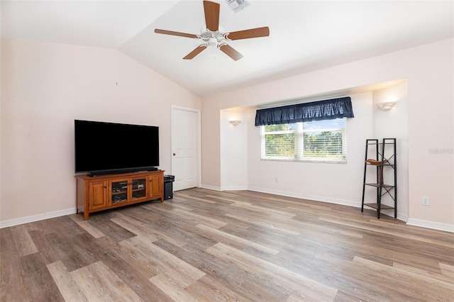 1730 Hudson St, Englewood, FL 34223 - unfurnished living room with a ceiling fan, light wood-type flooring, vaulted ceiling, and baseboards
