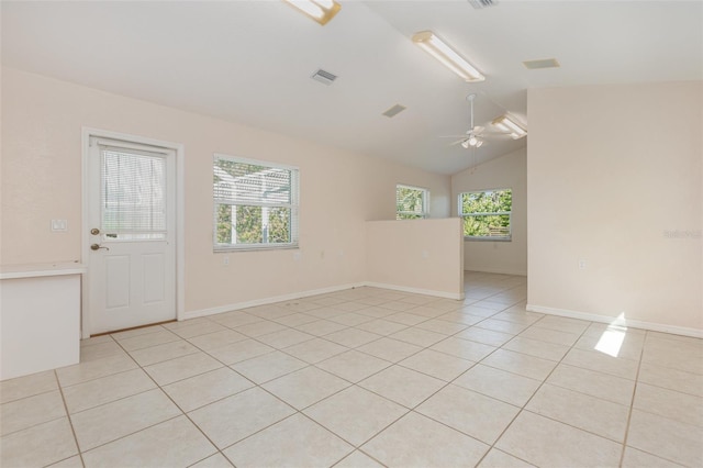 1730 Hudson St, Englewood, FL 34223 - spare room with a ceiling fan, light tile patterned floors, lofted ceiling, and baseboards