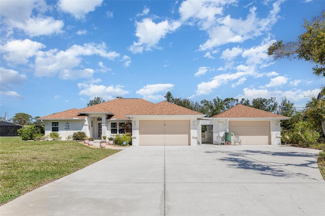 1730 Hudson St, Englewood, FL 34223 - ranch-style home with a garage, driveway, stucco siding, and a front lawn