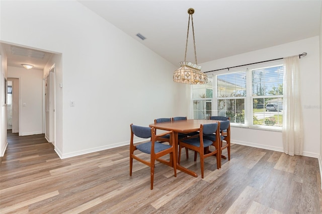 1730 Hudson St, Englewood, FL 34223 - dining area with light wood-style flooring, lofted ceiling, and baseboards