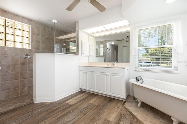 1730 Hudson St, Englewood, FL 34223 - bathroom with a ceiling fan, walk in shower, vanity, wood finished floors, and a freestanding tub