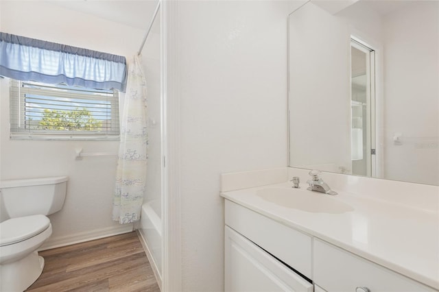 1730 Hudson St, Englewood, FL 34223 - bathroom with toilet, vanity, wood finished floors, shower / tub combo, and baseboards