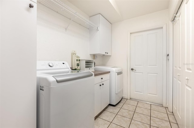 1730 Hudson St, Englewood, FL 34223 - laundry room with cabinet space, independent washer and dryer, and light tile patterned flooring