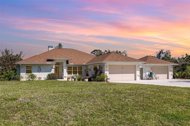 1730 Hudson St, Englewood, FL 34223 - ranch-style home with concrete driveway, a garage, stucco siding, and a lawn