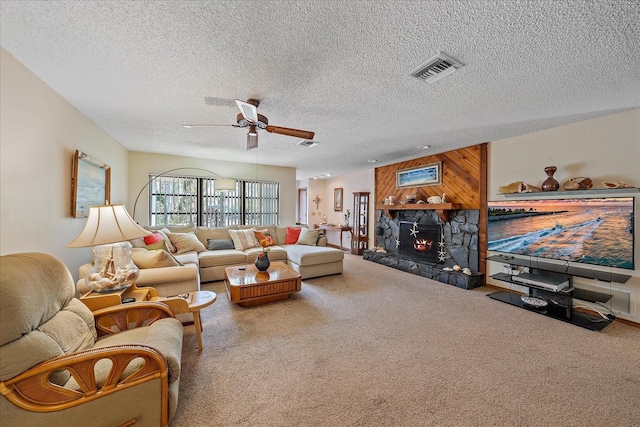 living area with wooden walls, a fireplace, carpet flooring, a ceiling fan, and visible vents