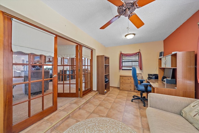 office area featuring french doors, built in desk, light tile patterned floors, a ceiling fan, and a textured ceiling