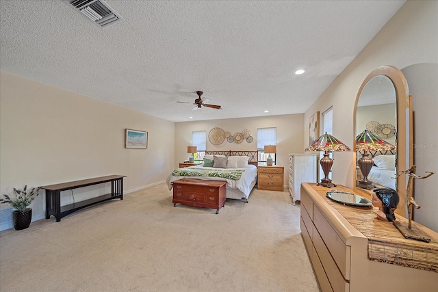 bedroom with recessed lighting, light colored carpet, visible vents, a textured ceiling, and baseboards