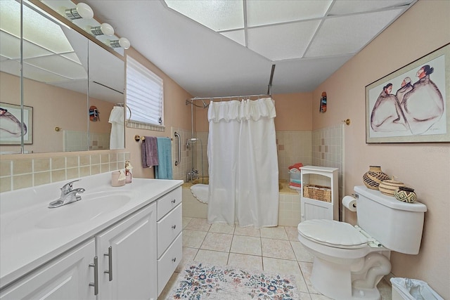 full bathroom featuring toilet, tile patterned flooring, shower / bath combination with curtain, and vanity