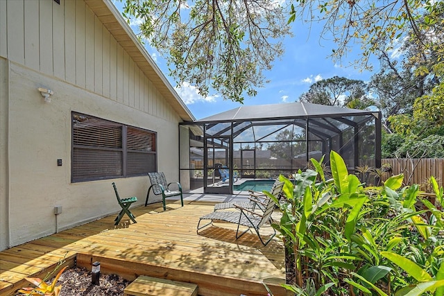 deck with a fenced in pool, a lanai, and fence