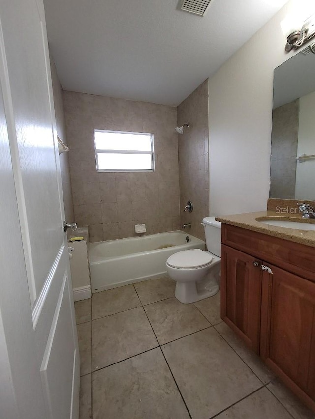 bathroom featuring visible vents, toilet, vanity, shower / tub combination, and tile patterned flooring