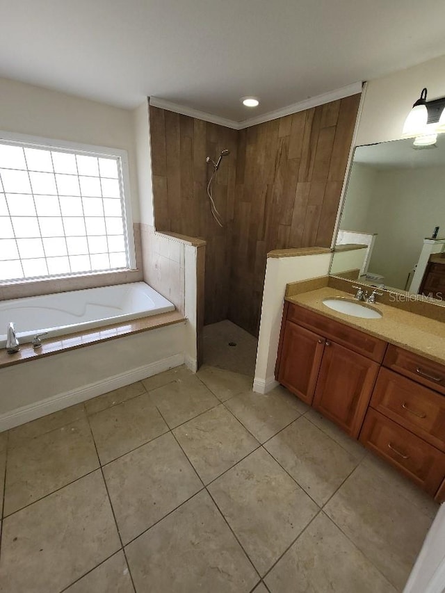 full bathroom featuring tile patterned floors, a tile shower, vanity, and a bath