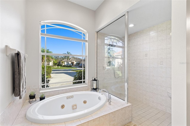 full bathroom with a whirlpool tub and tiled shower