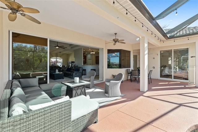 view of patio with a ceiling fan, outdoor dining area, glass enclosure, and an outdoor hangout area