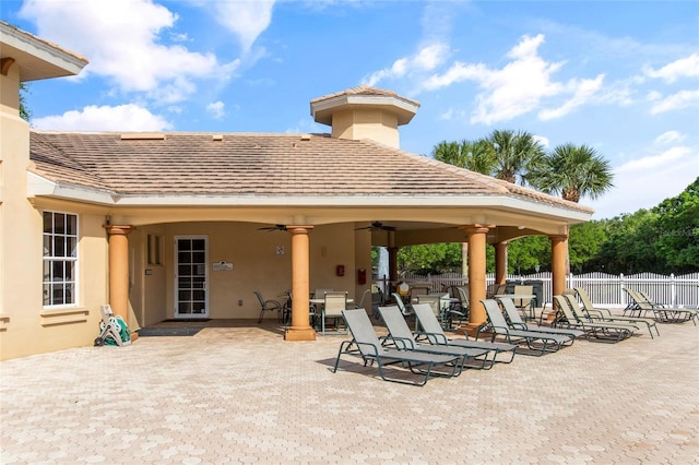 view of patio featuring a ceiling fan and fence