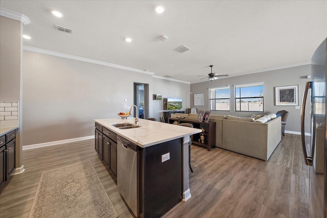 kitchen featuring dishwasher, light wood-style flooring, a sink, and visible vents