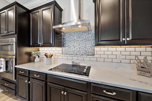 kitchen with light stone counters, tasteful backsplash, stainless steel double oven, wall chimney range hood, and black electric cooktop