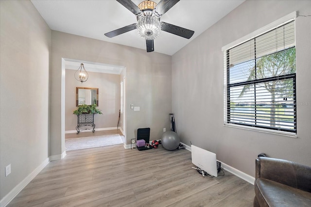 interior space featuring light wood-type flooring, ceiling fan, and baseboards