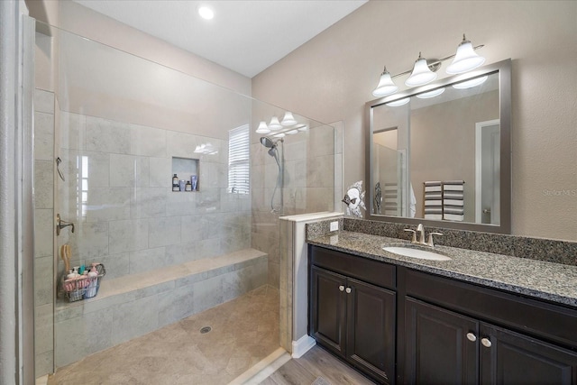 full bath featuring a walk in shower and vanity