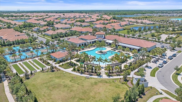 birds eye view of property featuring a water view and a residential view