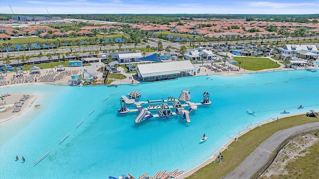 drone / aerial view with a water view and a residential view