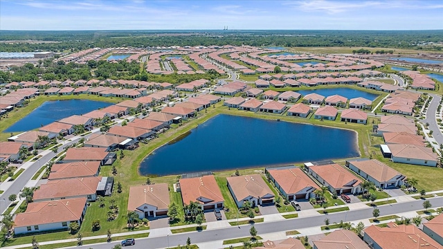 drone / aerial view featuring a water view and a residential view