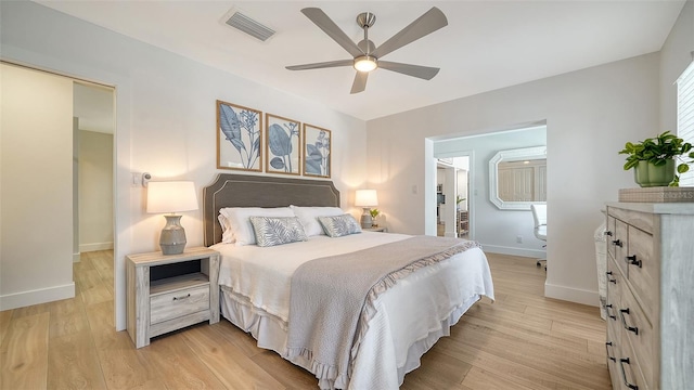 bedroom with visible vents, baseboards, light wood-style floors, and a ceiling fan