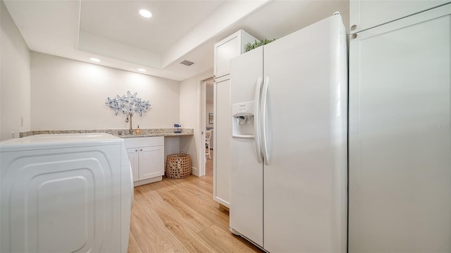 laundry area with light wood finished floors, visible vents, recessed lighting, cabinet space, and washer / clothes dryer