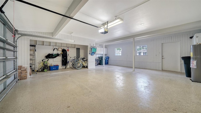 garage featuring water heater and a garage door opener