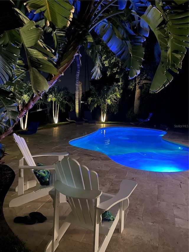 view of swimming pool with a jacuzzi and a patio