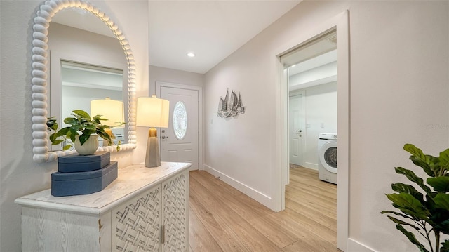 interior space with recessed lighting, washer / dryer, baseboards, and light wood-style floors