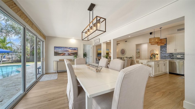 dining space featuring visible vents and light wood-style flooring