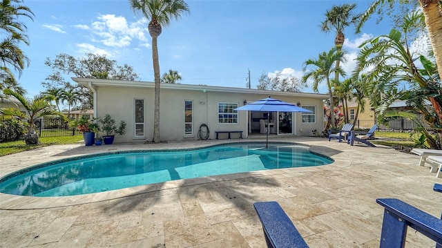 view of swimming pool featuring a fenced in pool, a patio, and fence