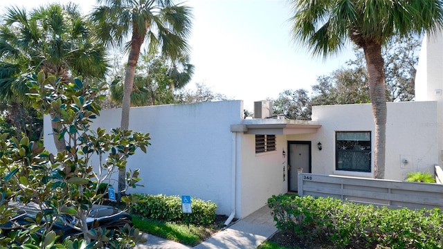 view of front of home featuring a fenced front yard, cooling unit, and stucco siding