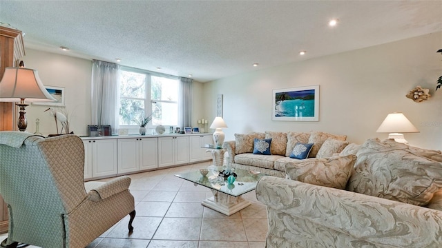 living area with recessed lighting, a textured ceiling, and light tile patterned flooring