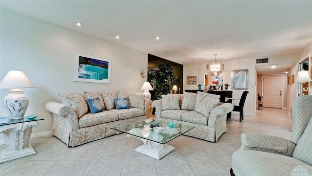 living area with a notable chandelier, recessed lighting, visible vents, light tile patterned flooring, and baseboards