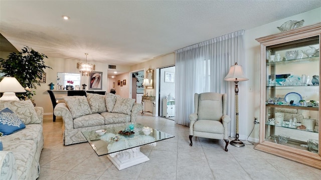 living room featuring a textured ceiling, visible vents, a wealth of natural light, and light tile patterned flooring