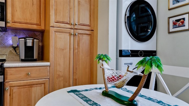 dining area featuring stacked washer and clothes dryer