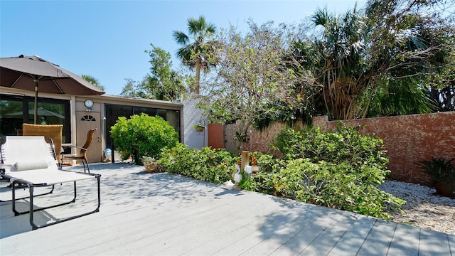 view of patio featuring fence and a wooden deck