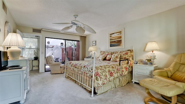 bedroom with a textured ceiling, ceiling fan, light colored carpet, visible vents, and access to outside