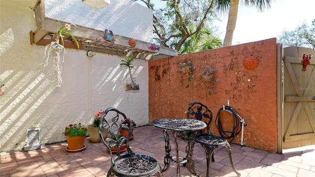 view of patio featuring fence