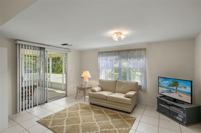 tiled living room with visible vents and baseboards