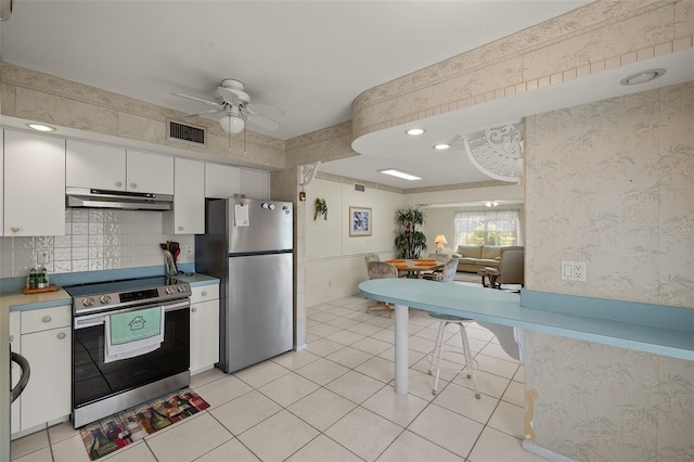 kitchen with stainless steel appliances, visible vents, white cabinetry, under cabinet range hood, and wallpapered walls