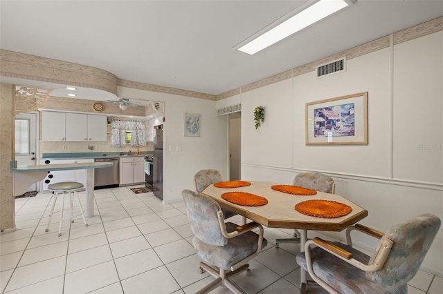 dining space featuring light tile patterned floors and visible vents