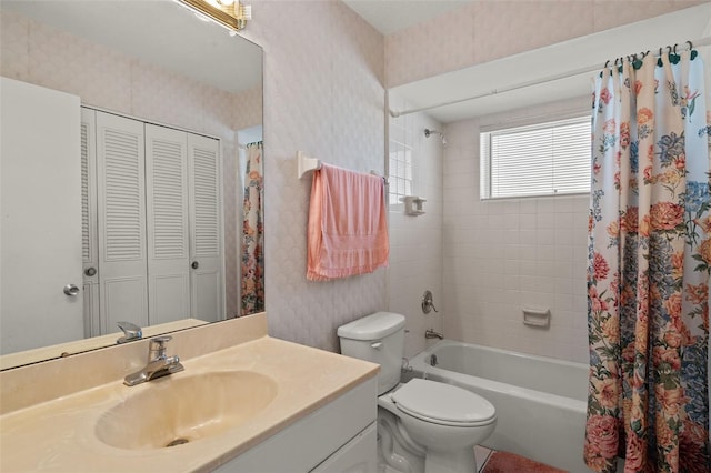 bathroom with wallpapered walls, toilet, shower / tub combo with curtain, vanity, and a closet