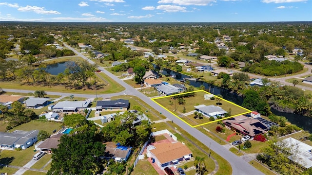 drone / aerial view with a residential view and a water view